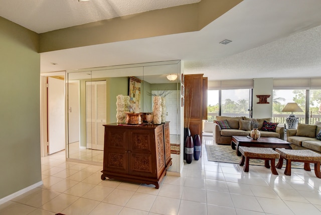 interior space with light tile floors and a textured ceiling