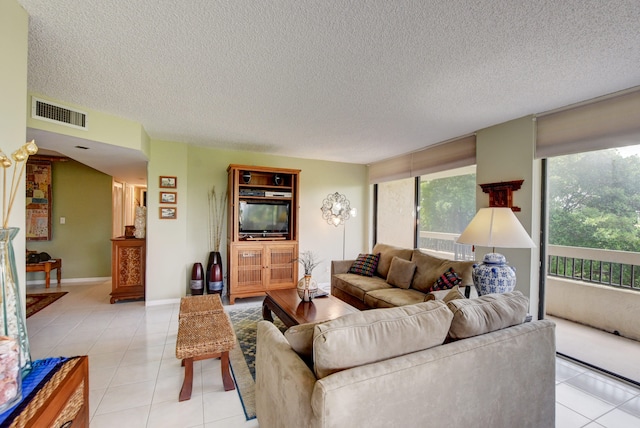 tiled living room featuring a textured ceiling