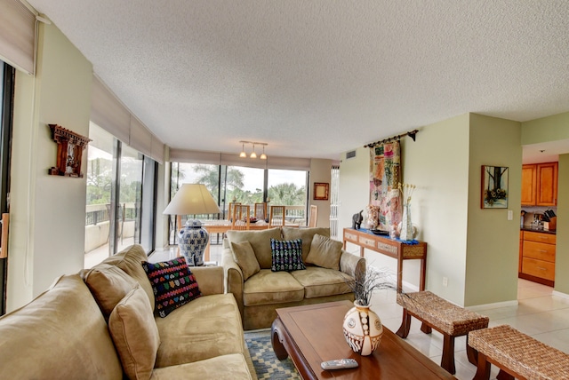 living room with light tile floors and a textured ceiling