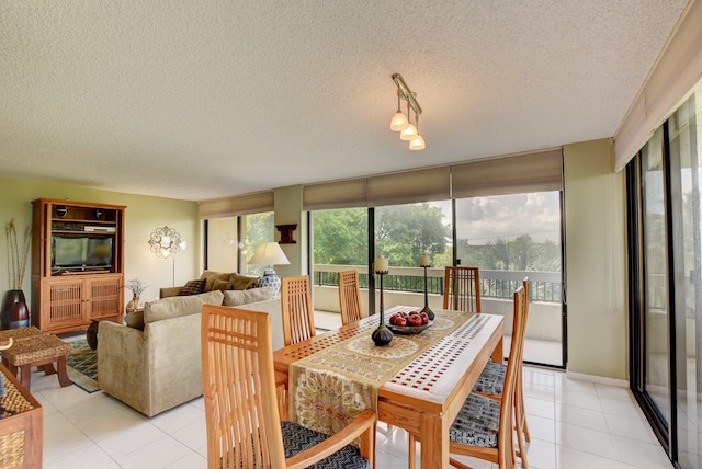 dining space with light tile floors and a textured ceiling