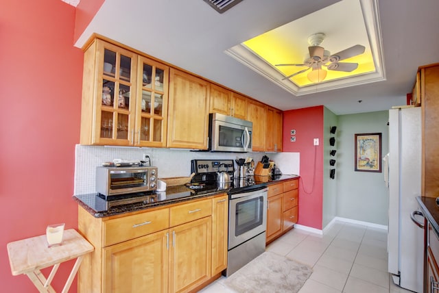 kitchen featuring backsplash, appliances with stainless steel finishes, ceiling fan, and a raised ceiling