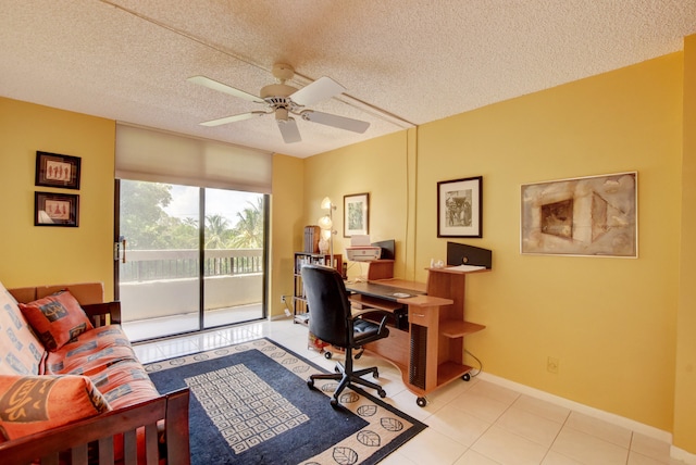 tiled office space featuring a textured ceiling and ceiling fan