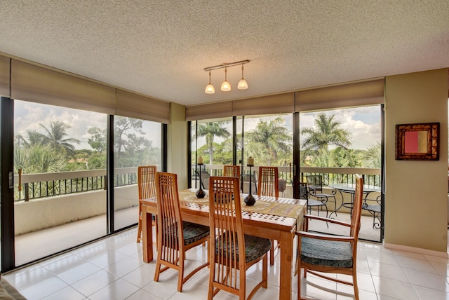 dining area with plenty of natural light, track lighting, light tile floors, and a textured ceiling