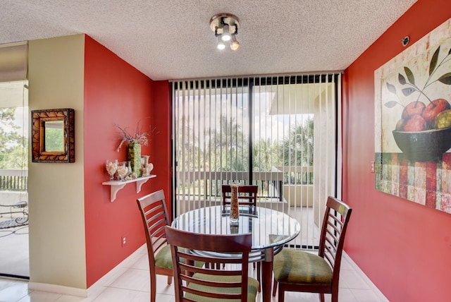 tiled dining room featuring a wealth of natural light and a textured ceiling