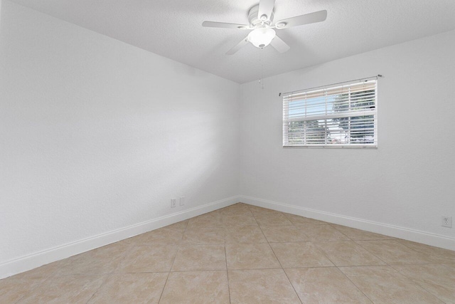 tiled empty room with a textured ceiling and ceiling fan