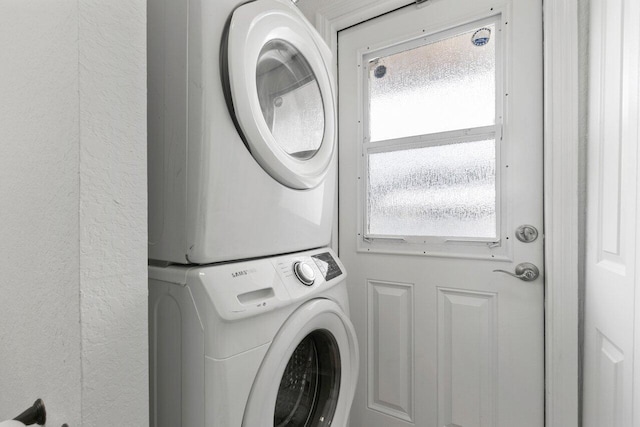 laundry area with stacked washer and dryer