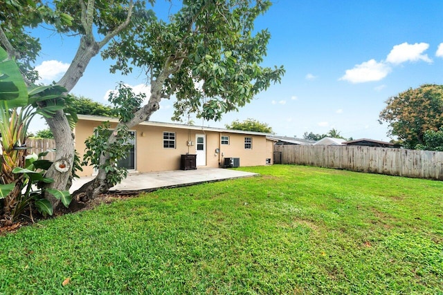 view of yard with a patio area and central air condition unit