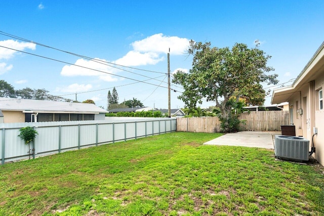 view of yard featuring central AC and a patio