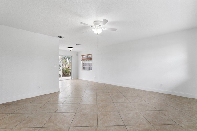 tiled empty room featuring ceiling fan