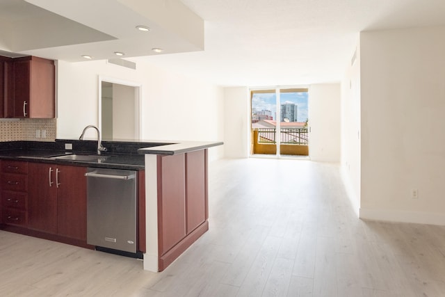 kitchen with dishwasher, sink, light wood-type flooring, and tasteful backsplash