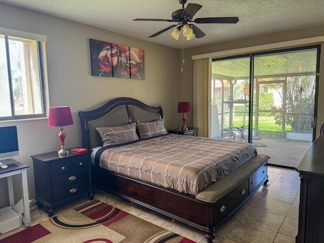 tiled bedroom featuring ceiling fan, a textured ceiling, and access to outside