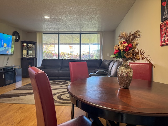 dining area featuring a textured ceiling and hardwood / wood-style floors