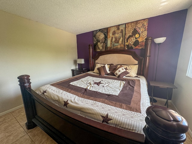 tiled bedroom featuring a textured ceiling