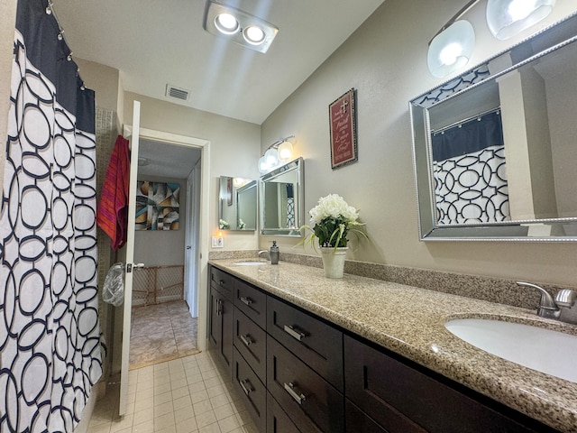 bathroom with double vanity and tile flooring