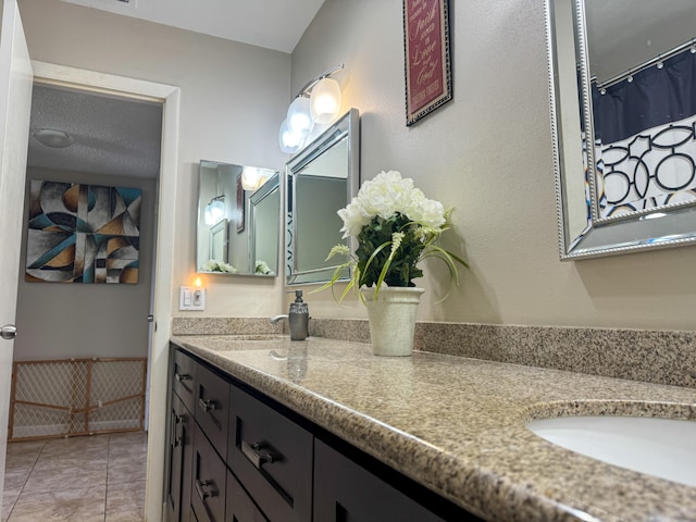 bathroom with tile flooring and large vanity