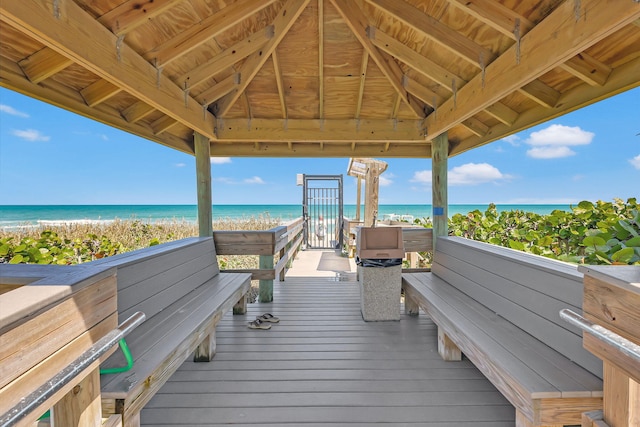 view of property's community with a view of the beach, a gazebo, and a water view