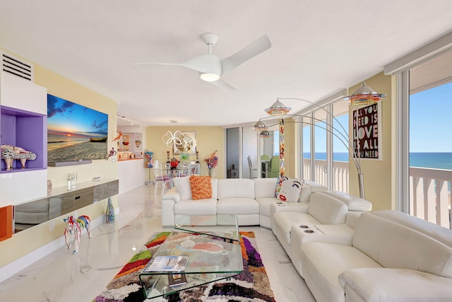 living room with a water view and a wall of windows