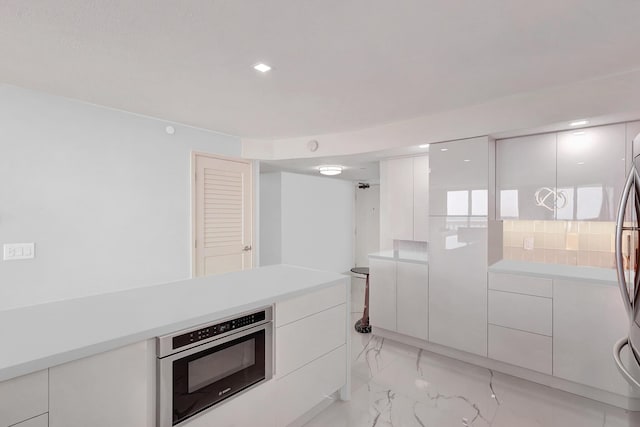 kitchen featuring light countertops, white cabinets, and appliances with stainless steel finishes