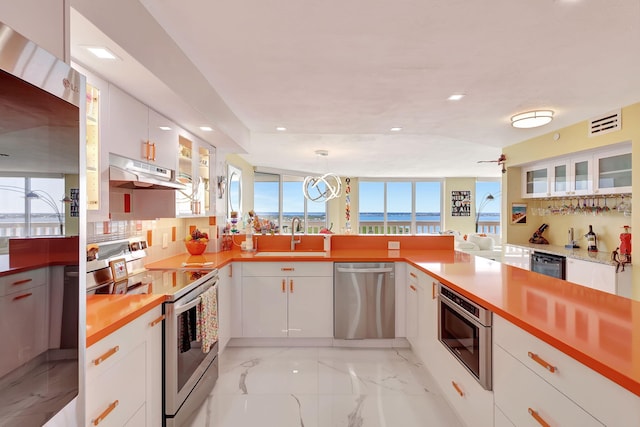 kitchen featuring decorative backsplash, white cabinets, and stainless steel appliances