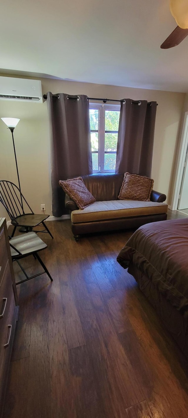 bedroom featuring an AC wall unit, dark hardwood / wood-style floors, and ceiling fan