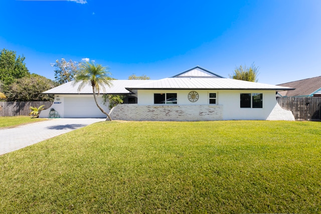 view of front of property with a front yard and a garage