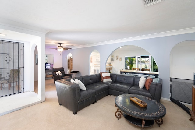 living room featuring crown molding, ceiling fan, and light carpet