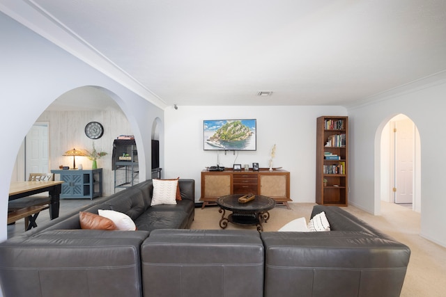 carpeted living room with ornamental molding