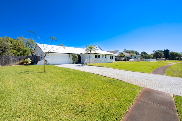 ranch-style house with a front yard and a garage