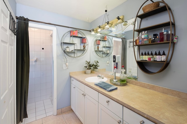 bathroom featuring tile flooring, vanity with extensive cabinet space, and tiled shower