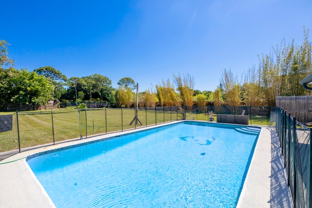 view of swimming pool with a lawn