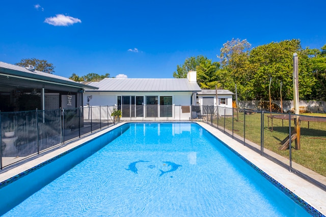 view of swimming pool with a lawn