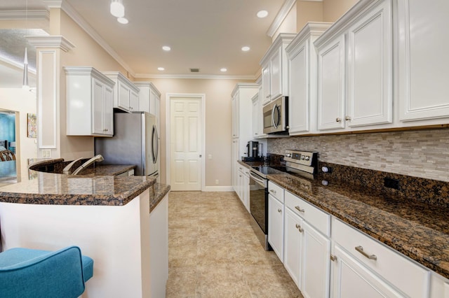 kitchen with light tile floors, dark stone counters, stainless steel appliances, tasteful backsplash, and white cabinetry