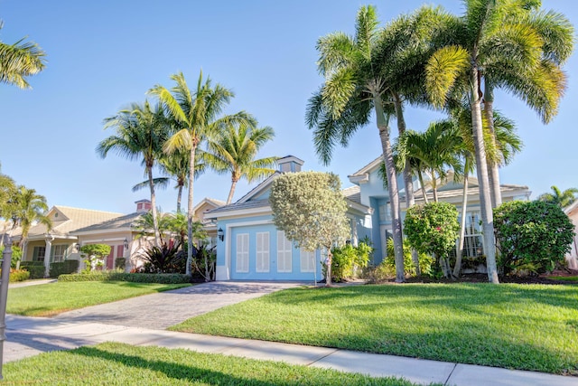 view of property hidden behind natural elements with a front lawn