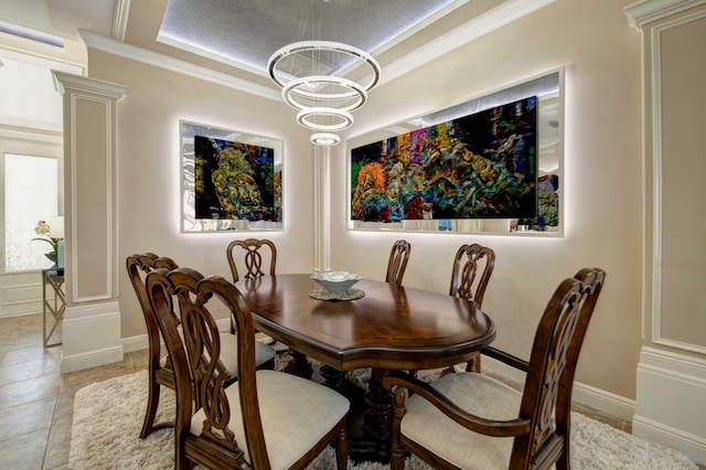 tiled dining area with an inviting chandelier, a textured ceiling, ornamental molding, and decorative columns