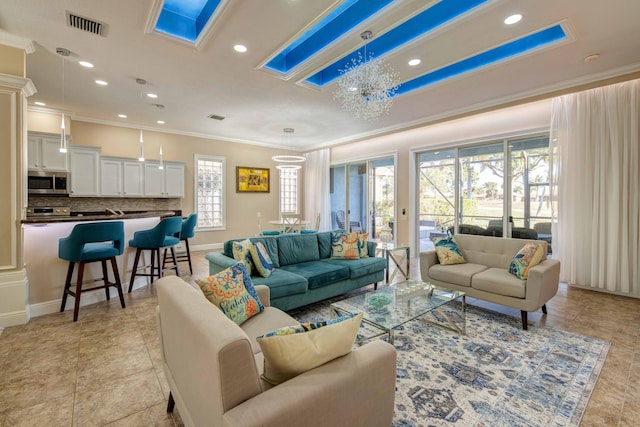 living room with a notable chandelier, plenty of natural light, and light tile flooring