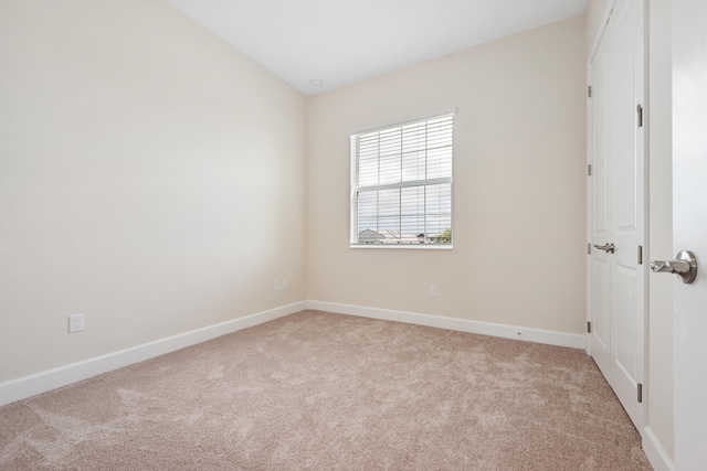 empty room with light carpet and lofted ceiling