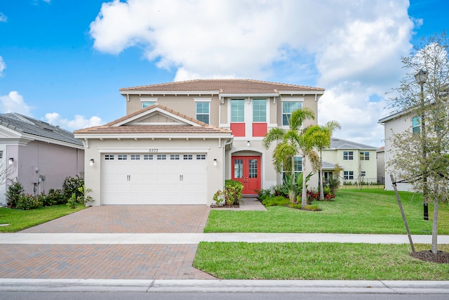 view of front of home with a front yard and a garage