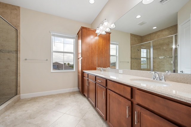 bathroom with a shower with door, tile floors, dual sinks, and large vanity