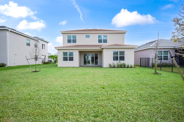 rear view of house with a yard