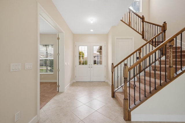 tiled entryway featuring french doors