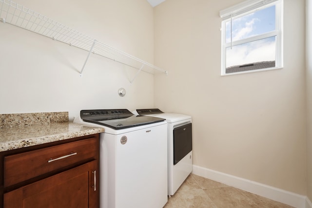 washroom with light tile floors and washing machine and clothes dryer