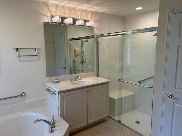 bathroom with shower with separate bathtub, vanity, and tile patterned floors