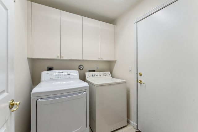 laundry area with cabinets and washing machine and clothes dryer