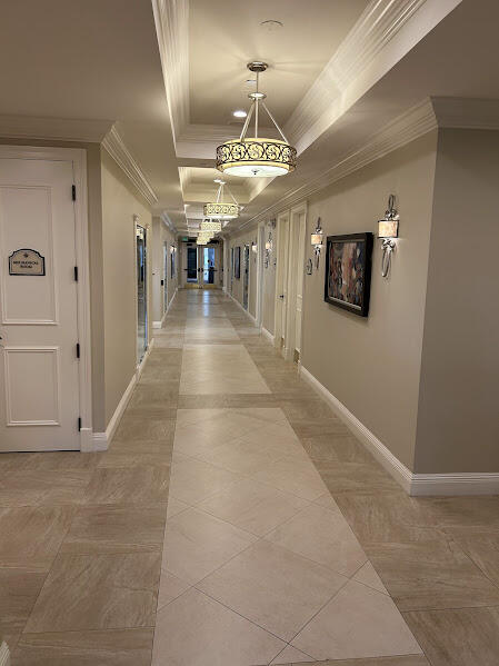 corridor featuring a tray ceiling and crown molding