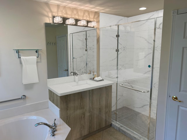 bathroom with tile patterned flooring, vanity, and shower with separate bathtub