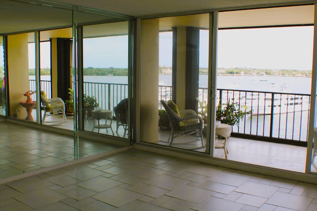 entryway with a water view and tile flooring