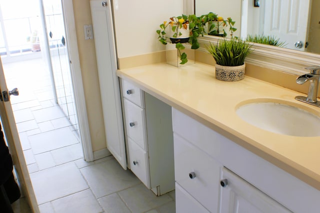 bathroom featuring tile floors and vanity with extensive cabinet space