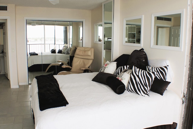 bedroom featuring a closet and tile floors