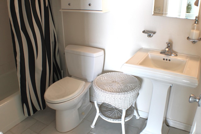 full bathroom featuring toilet, shower / tub combo, tile floors, and sink