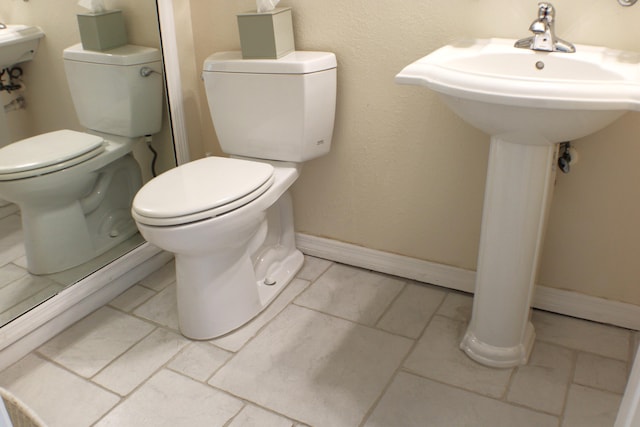 bathroom featuring tile floors and toilet